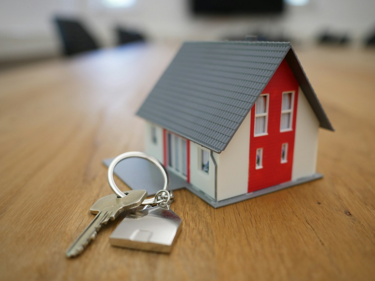 House keys beside a small model home