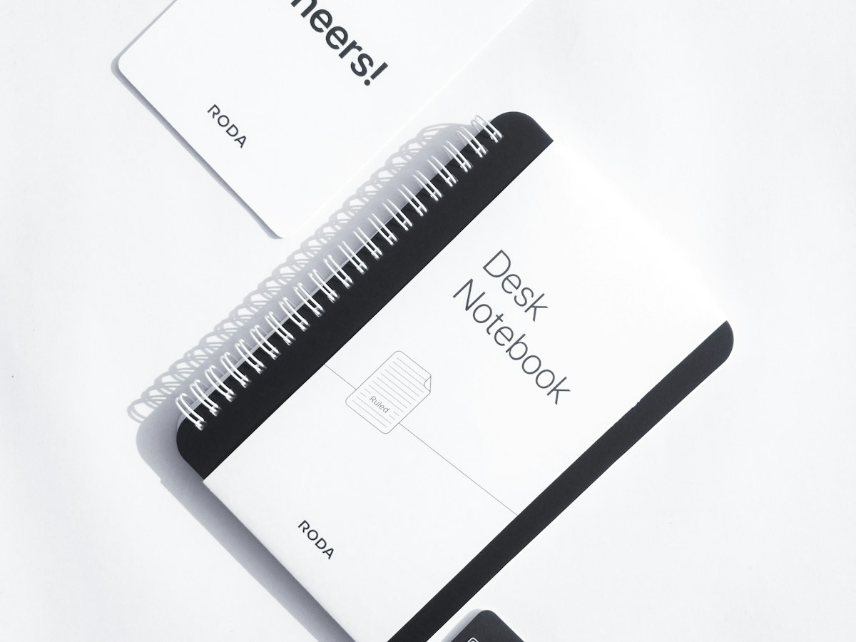 A spiral notebook on a light desk